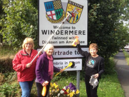 FairTrade Group members cleaning Gateway signs